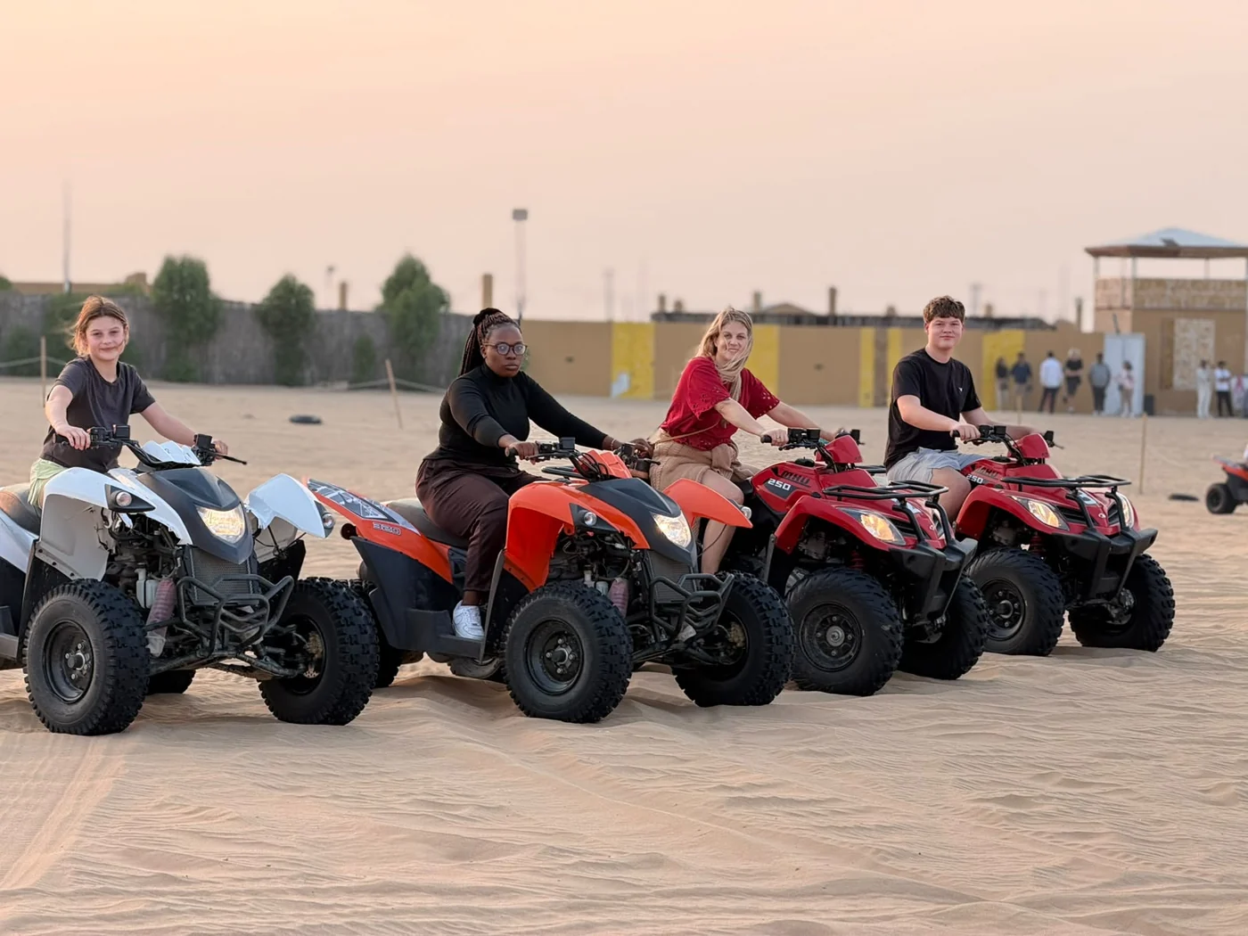 Guests riding quad bikes on a desert safari in Abu Dhabi